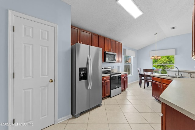 3130 Haverhill Ct, Green Cove Springs, FL 32043 - kitchen with an inviting chandelier, light tile patterned flooring, a sink, stainless steel appliances, and vaulted ceiling