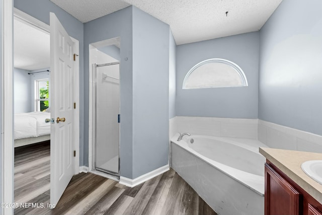 3130 Haverhill Ct, Green Cove Springs, FL 32043 - ensuite bathroom with a stall shower, a textured ceiling, vanity, and wood finished floors