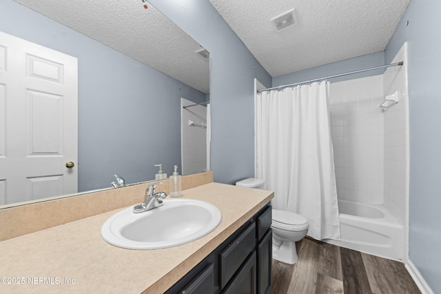 3130 Haverhill Ct, Green Cove Springs, FL 32043 - bathroom with visible vents, toilet, vanity, wood finished floors, and a textured ceiling