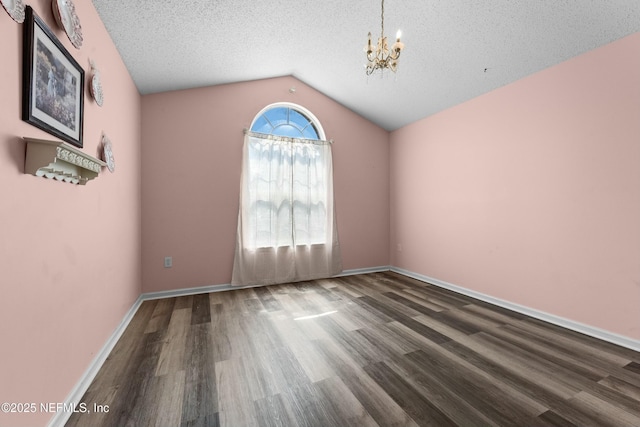 3130 Haverhill Ct, Green Cove Springs, FL 32043 - empty room with baseboards, vaulted ceiling, an inviting chandelier, wood finished floors, and a textured ceiling