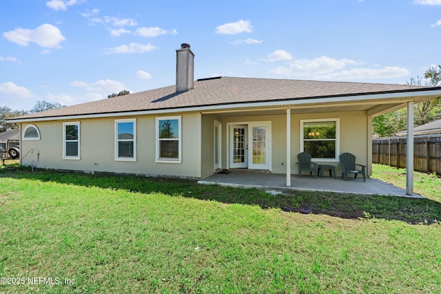 3130 Haverhill Ct, Green Cove Springs, FL 32043 - back of house featuring stucco siding, fence, a yard, a chimney, and a patio area