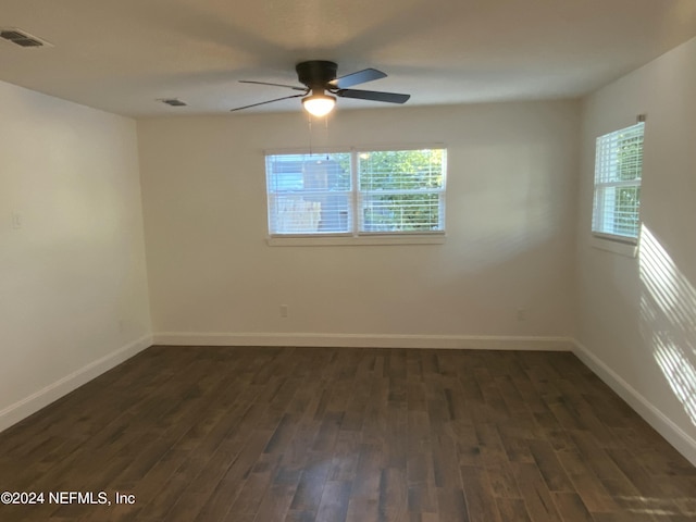 spare room featuring dark hardwood / wood-style floors, a healthy amount of sunlight, and ceiling fan