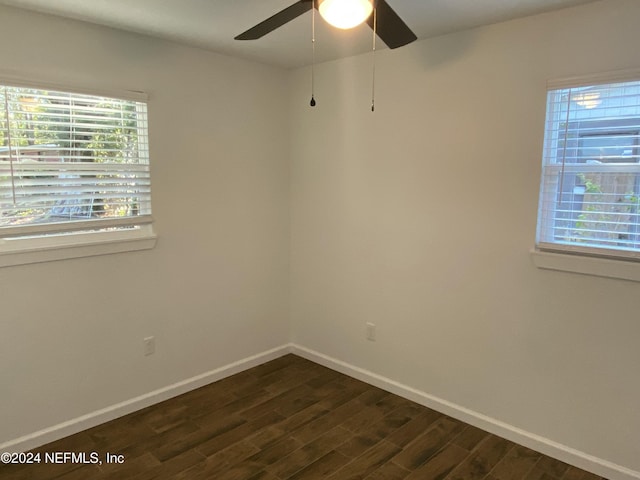 spare room with dark hardwood / wood-style floors and ceiling fan