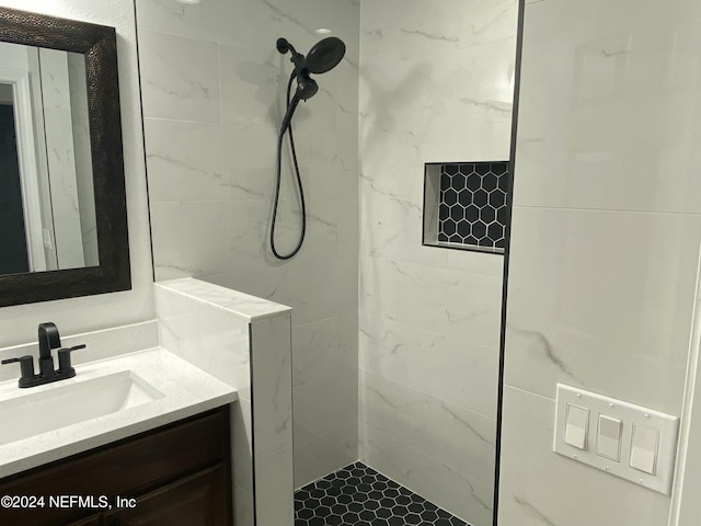 bathroom with vanity and tiled shower