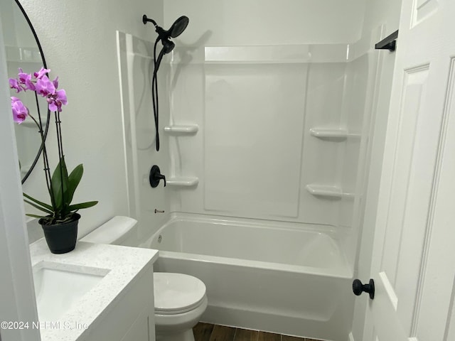 full bathroom featuring washtub / shower combination, wood-type flooring, vanity, and toilet