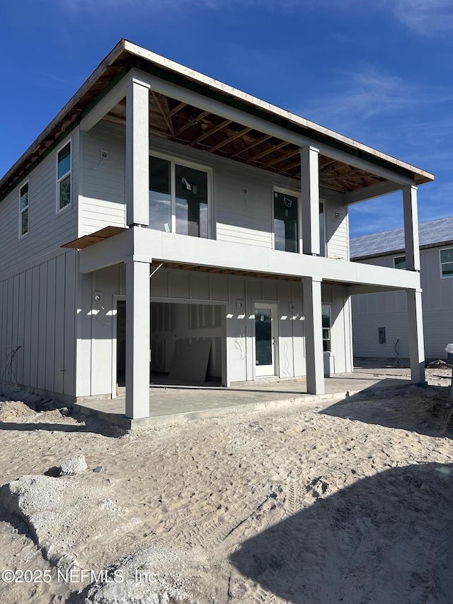 back of house featuring board and batten siding