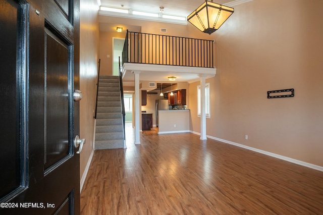 foyer entrance featuring wood-type flooring and ornamental molding