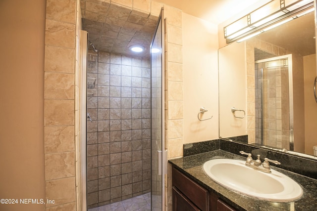 bathroom featuring vanity and a shower with shower door