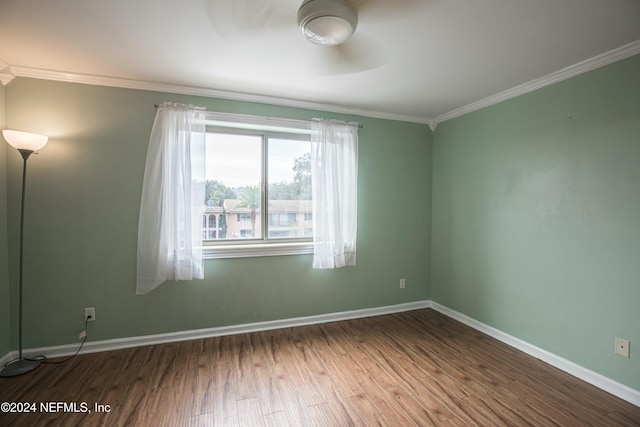 spare room featuring crown molding and hardwood / wood-style flooring