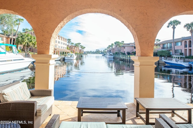 dock area with a patio area and a water view