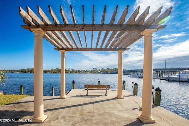 view of dock with a pergola and a water view