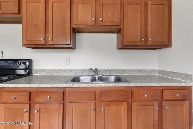 kitchen featuring black electric range and sink