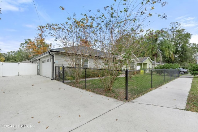 view of front facade with a front yard and a garage