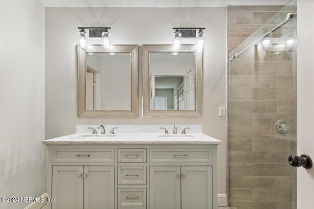 bathroom featuring vanity and a shower with door