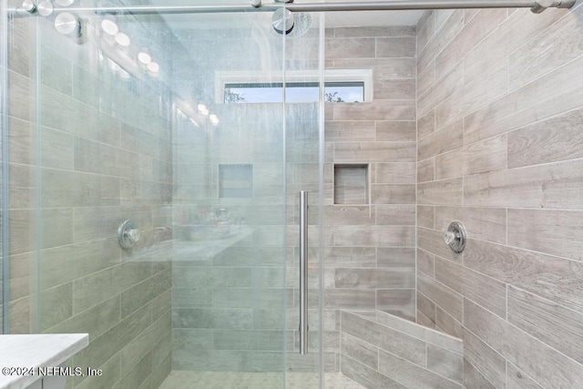 bathroom with vanity and a shower with shower door