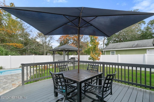 wooden terrace with a gazebo, a fenced in pool, and a yard