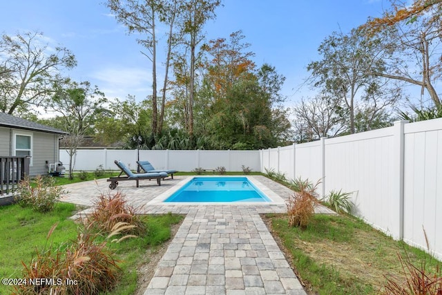 view of swimming pool with a yard and a patio