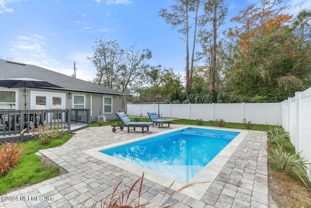 view of pool featuring a patio area and french doors