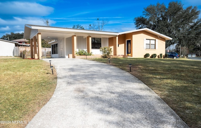 ranch-style home featuring a front yard and a carport