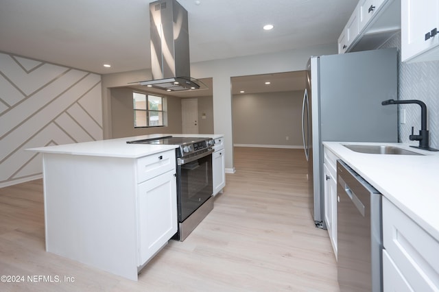 kitchen with island exhaust hood, black electric range oven, sink, dishwasher, and white cabinetry