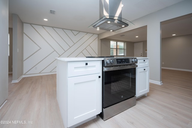 kitchen featuring island exhaust hood, electric range oven, white cabinetry, and light hardwood / wood-style flooring