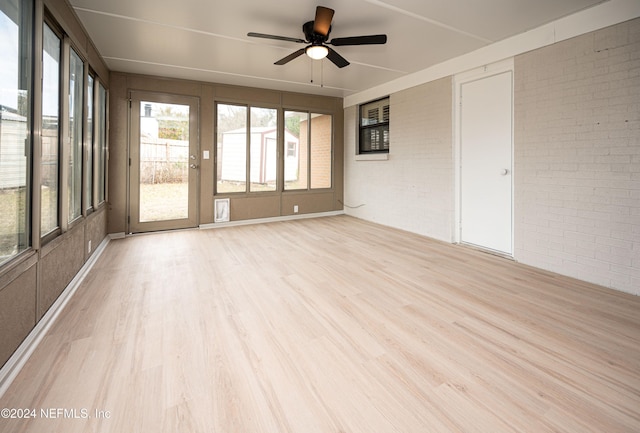 unfurnished sunroom featuring ceiling fan