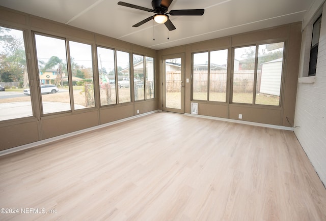 unfurnished sunroom with ceiling fan