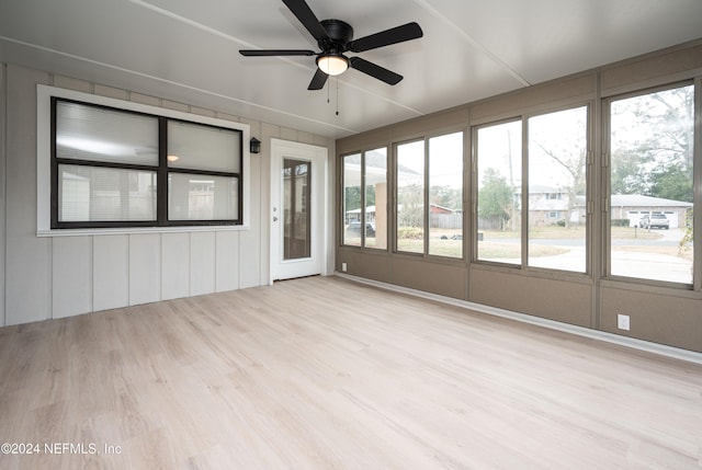 unfurnished sunroom with ceiling fan and a wealth of natural light