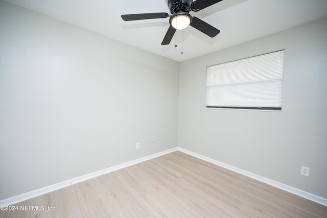 spare room with light wood-type flooring and ceiling fan