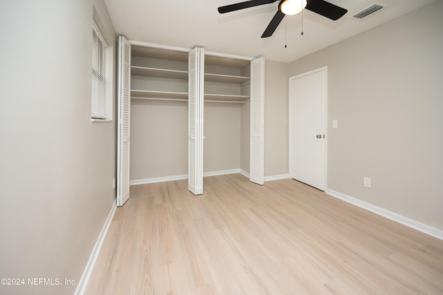 unfurnished bedroom with ceiling fan and light wood-type flooring