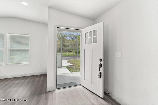 entrance foyer featuring light hardwood / wood-style flooring and lofted ceiling