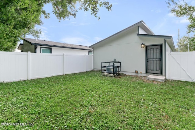 back of house with a yard