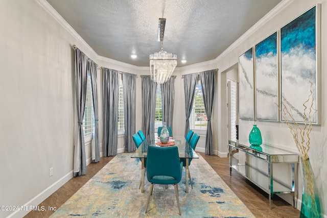 dining area featuring a notable chandelier, ornamental molding, and a textured ceiling