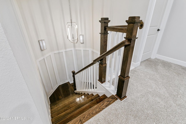 staircase featuring carpet