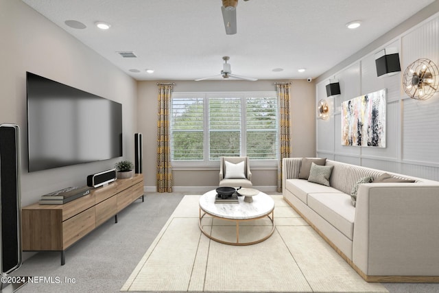 carpeted living room with ceiling fan