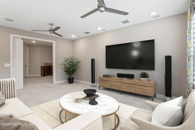 living room featuring radiator, light colored carpet, and ceiling fan