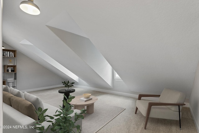 bonus room with light colored carpet and vaulted ceiling with skylight