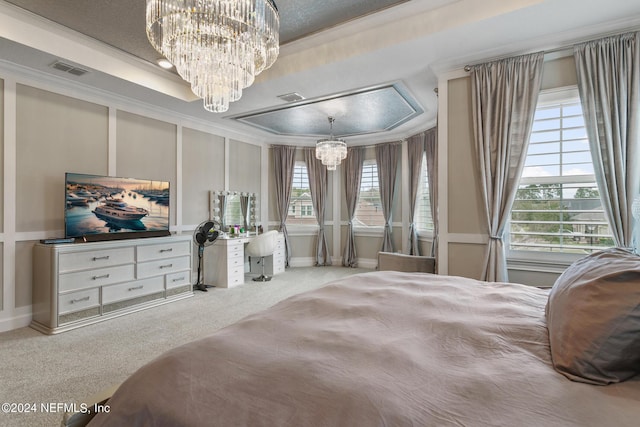 bedroom with an inviting chandelier, a tray ceiling, crown molding, and carpet floors