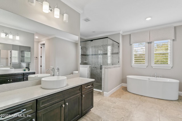 bathroom featuring crown molding, vanity, and shower with separate bathtub