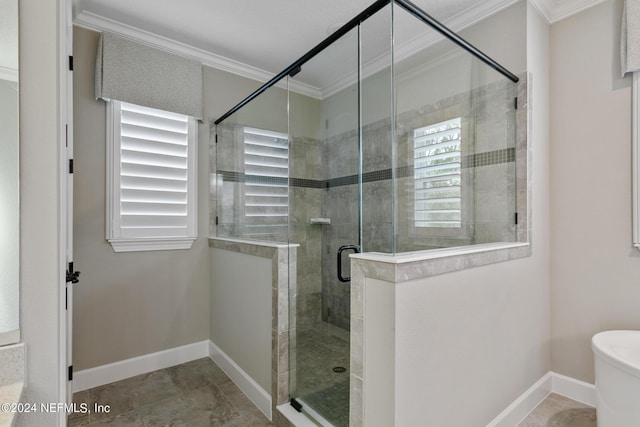 bathroom with crown molding and a shower with shower door