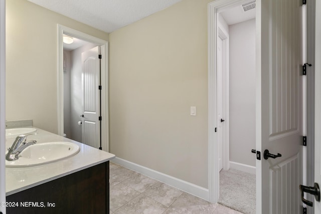 bathroom with vanity, tile patterned flooring, and a textured ceiling