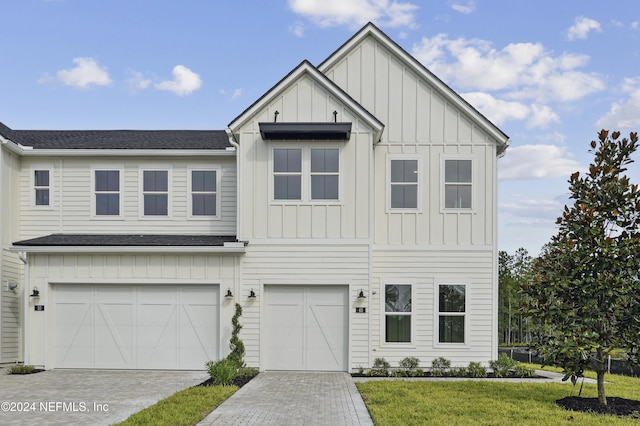 view of front facade with a front yard and a garage