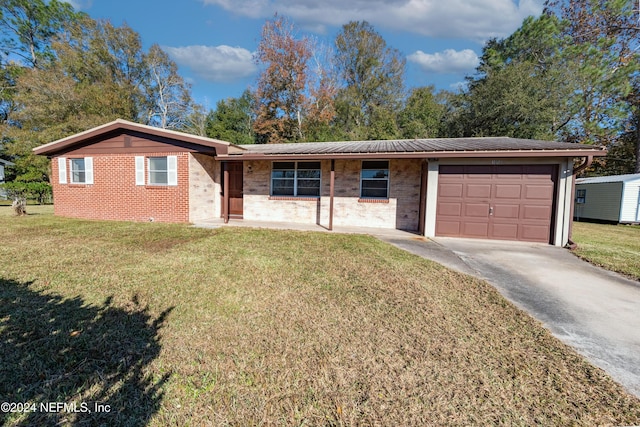 single story home featuring a front lawn and a garage