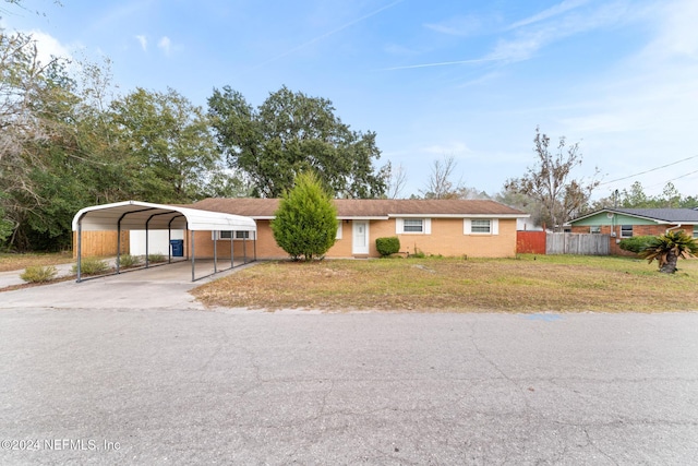 single story home featuring a front yard and a carport