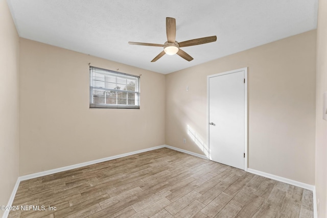 spare room with light hardwood / wood-style floors and ceiling fan