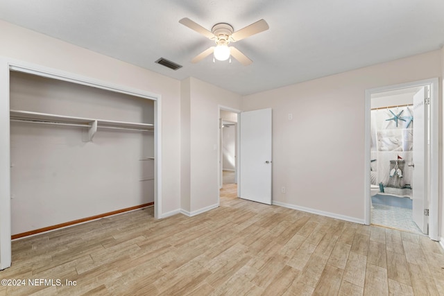 unfurnished bedroom with ceiling fan, light hardwood / wood-style floors, a closet, and ensuite bath