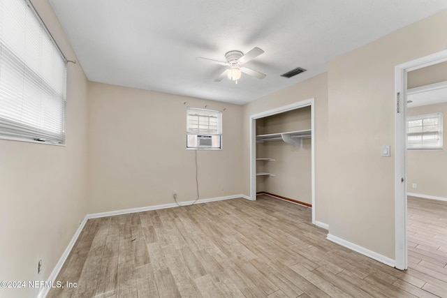 unfurnished bedroom with ceiling fan, a closet, and light hardwood / wood-style flooring