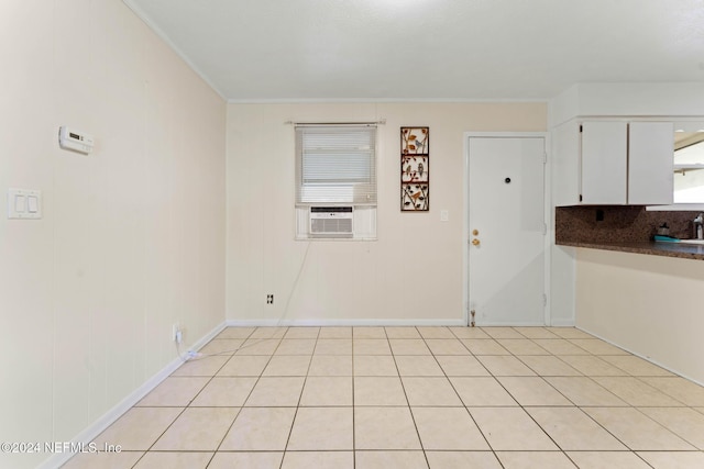 interior space with cooling unit, crown molding, and light tile patterned flooring