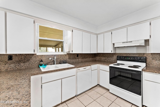 kitchen with tasteful backsplash, white cabinetry, sink, and white appliances