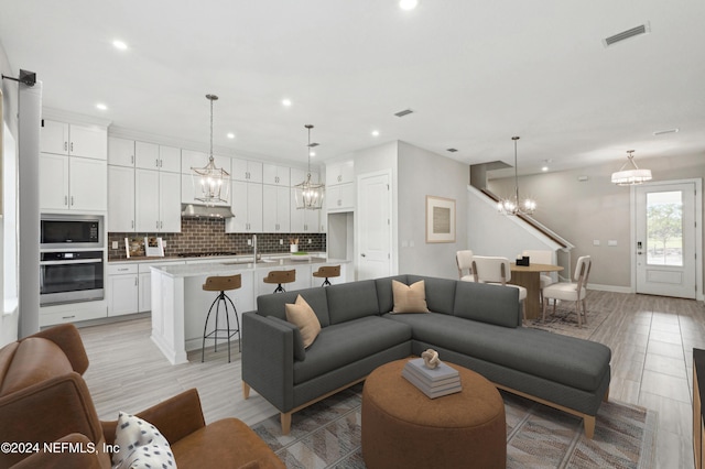 living room with light hardwood / wood-style flooring and sink